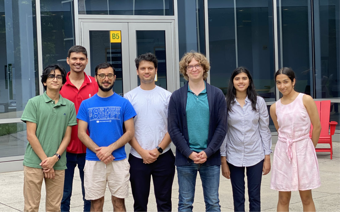 A photo of seven people in front of a building. Three are high school summer students. One is me, Greg Stein, the faculty advisor, and three are my PhD students.
